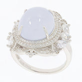 Oval white opal sterling silver ring with moissanite accent, showcasing elegant design and sparkling details.